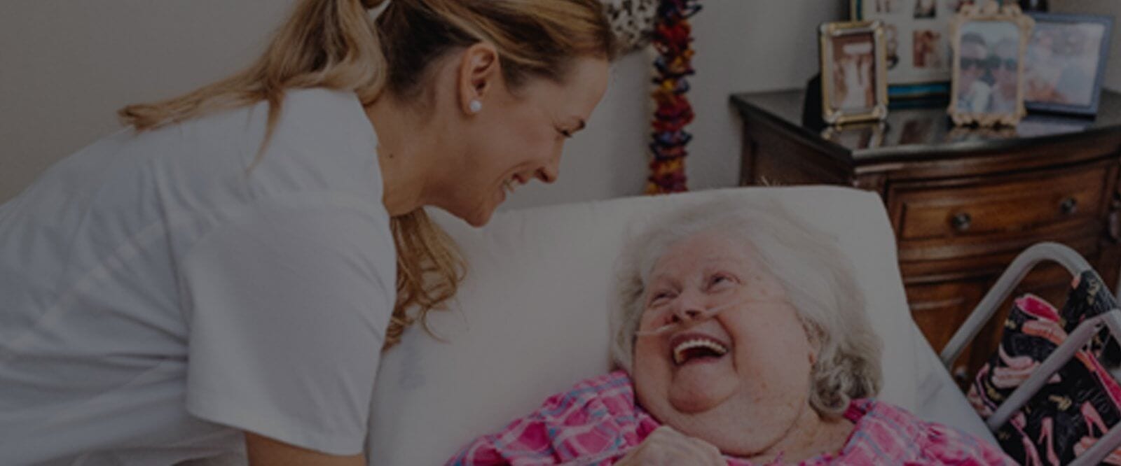Home Care Assistant Laughing With Elderly Woman