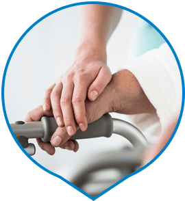 Home Care Assistant Holding Hands With Elderly Woman