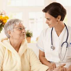 Home Care Assistant Checking Pulse of Elderly Woman